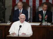 FILE - In this Thursday, Sept. 24, 2015 file photo, Pope Francis addresses a joint meeting of Congress on Capitol Hill in Washington, making history as the first pontiff to do so. Listening behind the pope are Vice President Joe Biden and House Speaker John Boehner of Ohio. President-elect Joe Biden, a lifelong Roman Catholic, spoke to Pope Francis on Thursday, Nov. 12, 2020, despite President Donald Trump refusing to concede. Trump claims -- without evidence -- that the election was stolen from him through massive but unspecified acts of fraud.