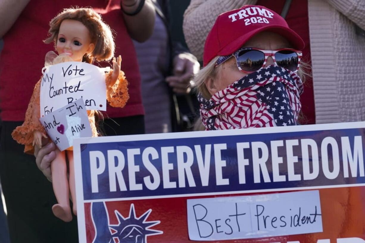 FILE- In a Nov. 7, 2020 file photo, a supporter of President Donald Trump is seen during a rally in Milwaukee after it was announced that the president was defeated by Democrat Joe Biden. President Trump will have to pay $7.9 million if he wants a statewide recount of unofficial results showing him losing to Biden by about 20,500 votes. The Wisconsin Elections Commission released the estimate on Monday, which was based on costs submitted by the 72 counties.