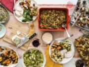 This October 2017 photo taken in New York, shows a Thanksgiving spread with hot spinach and mushroom dip, turkey, cornbread stuffing and sauteed brussel sprouts. A meal like this can be cooked and readied to be enjoyed in multiple homes and connected via Zoom, or virtually, during this year&#039;s Thanksgiving holiday.