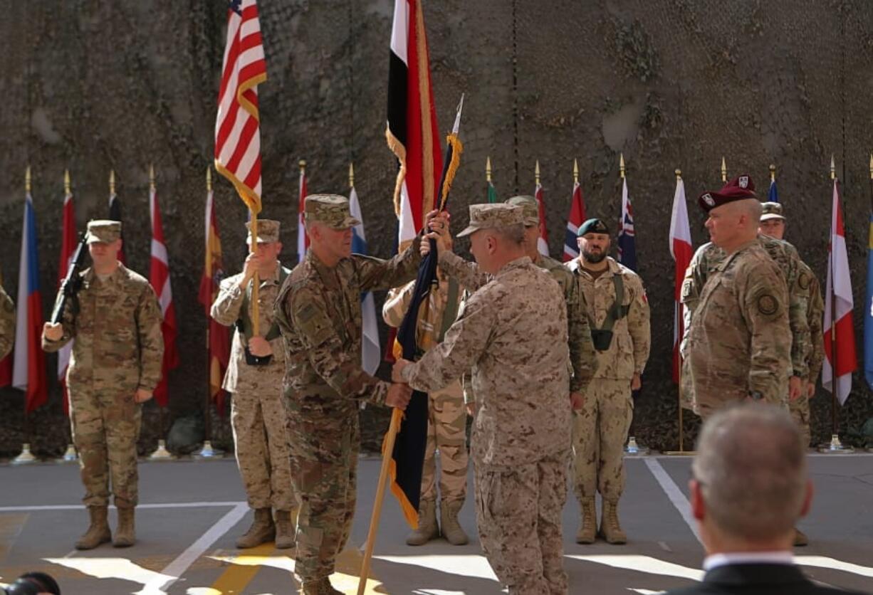 FILE - In this Sept. 14, 2019, file photo U.S. Army Lt. Gen. Pat White, III Armored Corps Commanding General, center left, and Commanding General for U.S. Central Command Gen. Kenneth F. McKenzie Jr. center right, take part in a transfer authority ceremony at Union III, base in Baghdad, Iraq, Saturday, Sept. 14, 2019. White is the Fort Hood commander and he is facing the grim task of rebuilding trust and turning around an installation that has one of the highest rates of murder, sexual assault and harassment in the Army.