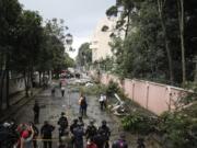 Police officers stand guard at the area where a plane that crashed in Guatemala City, Sunday, Nov. 8, 2020. A plane crashed after taking off from Guatemala City&#039;s La Aurora Airport with humanitarian aid to the areas affected by the ETA storm. At least one person died in the accident, firefighters reported.