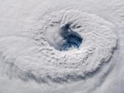 FILE - In this Sept. 12, 2018 photo provided by NASA, Hurricane Florence churns over the Atlantic Ocean heading for the U.S. east coast as seen from the International Space Station. Astronaut Alexander Gerst, who shot the photo, tweeted: &quot;Ever stared down the gaping eye of a category 4 hurricane?