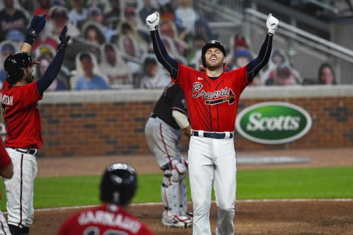 Atlanta Braves&#039; Freddie Freeman celebrates as he crosses home plate after hitting a grand slam against the Washington Nationals ion Sept. 4, 2020. Freeman easily won the NL MVP award Thursday, Nov.