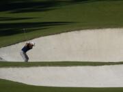 Dustin Johnson hits out of a bunker on the eighth hole during the second round of the Masters golf tournament Friday, Nov. 13, 2020, in Augusta, Ga. (AP Photo/David J.