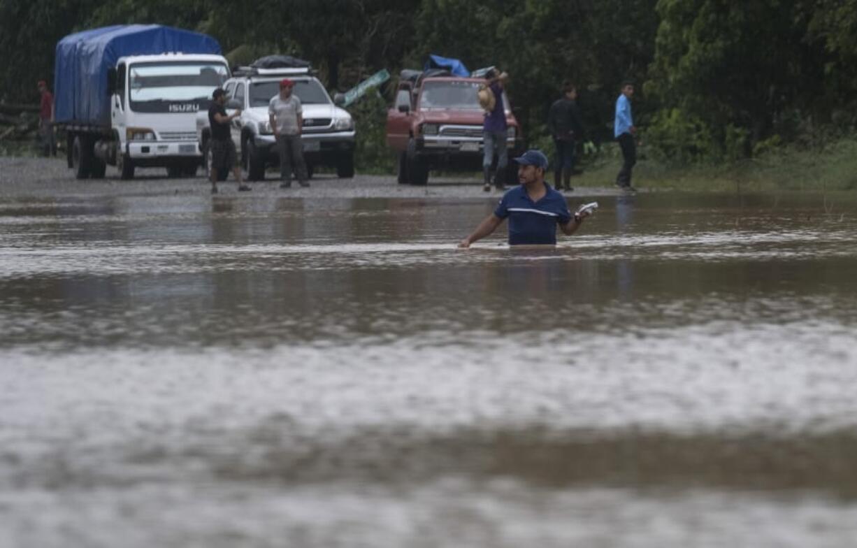 A man walks through a flooded road in Okonwas, Nicaragua, Wednesday, Nov. 4, 2020. Eta weakened from the Category 4 hurricane to a tropical storm after lashing Nicaragua&#039;s Caribbean coast for much of Tuesday, its floodwaters isolating already remote communities and setting off deadly landslides.