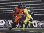 Oregon State running back Jermar Jefferson (6) runs past Oregon cornerback Mykael Wright (2) and into the end zone for a first-quarter touchdown on Friday. Jefferson finished with 226 yards rushing on 29 carries and two touchdowns.