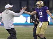 Washington head coach Jimmy Lake, left, greets starting quarterback Dylan Morris (9) after Washington beat Oregon State 27-21 in an NCAA college football game, Saturday, Nov. 14, 2020, in Seattle. The game was Lake&#039;s first since he was named head coach. (AP Photo/Ted S.