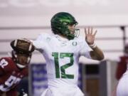 Oregon quarterback Tyler Shough (12) prepares to throw a pass during the first half of the team&#039;s NCAA college football game against Washington State in Pullman, Wash., Saturday, Nov. 14, 2020.