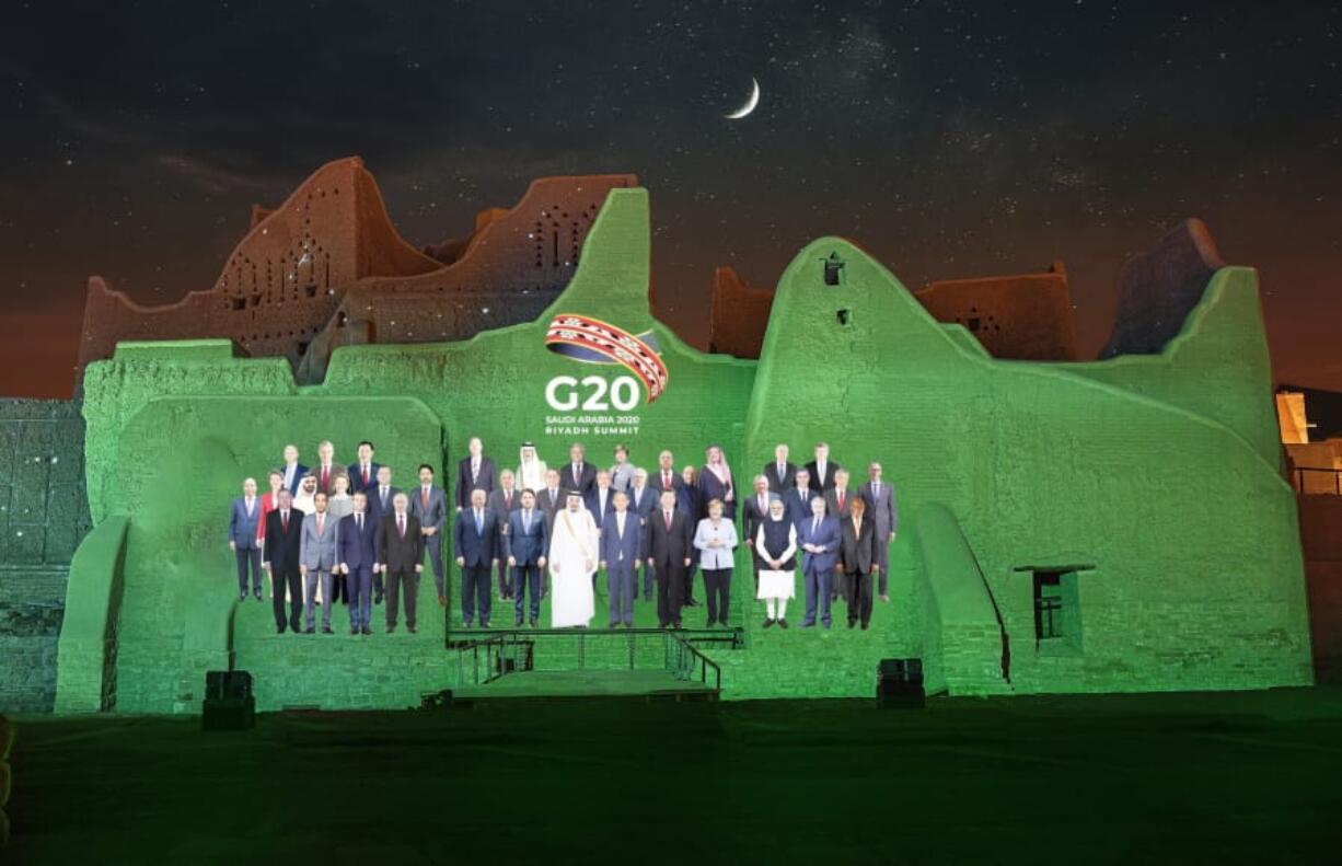 In this handout image provided by DGDA, Diriyah Gate Development Authority of Saudi, a family photo featuring members of the G20 is projected onto the walls of Salwa Palace, At Turaif on Saturday, Nov. 20, 2020 in Diriyah, on the outskirts of Riyadh, Saudi Arabia.