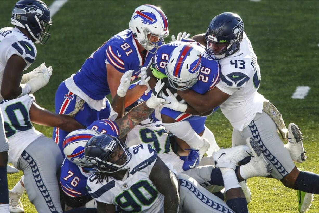 Seattle&#039;s Carlos Dunlap (43) tackles Buffalo&#039;s Devin Singletary (26) .