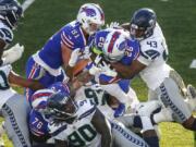 Seattle&#039;s Carlos Dunlap (43) tackles Buffalo&#039;s Devin Singletary (26) .