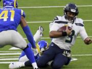 Seattle Seahawks quarterback Russell Wilson (3) scrambles against the Los Angeles Rams in the fourth quarter of an NFL football game in Inglewood, Calif., Sunday, Nov. 15, 2020.