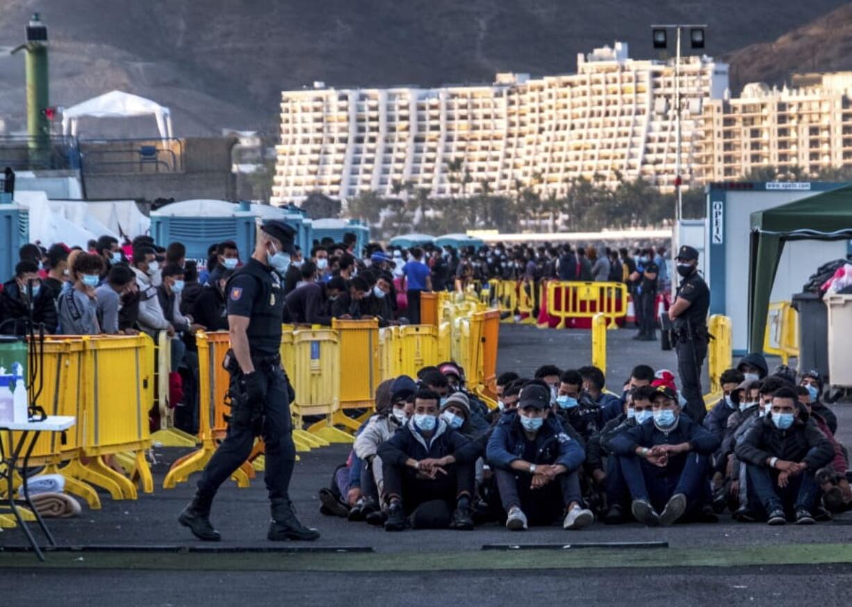 Migrants stand at the Arguineguin port in Gran Canaria island, Spain, after being rescued in the Atlantic Ocean by emergency workers on Thursday, Oct. 19, 2020. Under increasing pressure from the steady build-up of Africans&#039; arrivals to its southern Canary Islands, the Spanish government has launched an all-front offensive, including active diplomacy, to avoid becoming the next black spot on Europe&#039;s failing record handling migration flows.