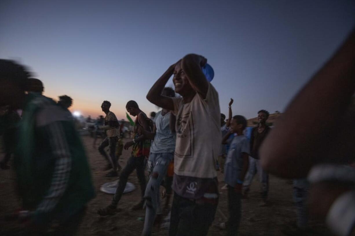 Tigray men who fled the conflict in Ethiopia&#039;s Tigray region, run to recieve cooked rice from charity organization Muslim Aid, at Umm Rakouba refugee camp in Qadarif, eastern Sudan, Friday, Nov. 27, 2020. Ethiopian Prime Minister Abiy Ahmed again ruled out dialogue with the leaders of the defiant Tigray region Friday but said he was willing to speak to representatives &quot;operating legally&quot; there during a meeting with three African Union special envoys trying to end the deadly conflict between federal troops and the region&#039;s forces.