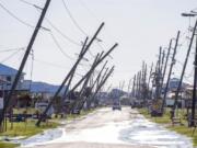 Power poles lean or are broken due to Hurricane Zeta damage Thursday Oct. 29, 2020,, in Grand Isle, La., as part of Gov. John Bel Edwards flyover of stricken areas in the southeastern part of the state.