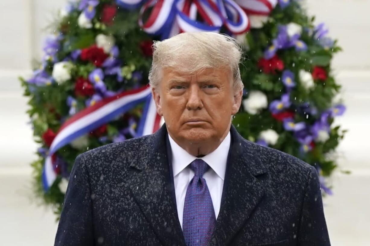 President Donald Trump participates in a Veterans Day wreath laying ceremony at the Tomb of the Unknown Soldier at Arlington National Cemetery in Arlington, Va., Wednesday, Nov. 11, 2020.