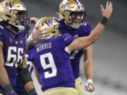 Washington quarterback Dylan Morris (9) celebrates with tight end Cade Otton, right, after Morris passed to Otton for a touchdown against Utah in the final minute of an NCAA college football game Saturday, Nov. 28, 2020, in Seattle. Washington won 24-21. (AP Photo/Ted S.