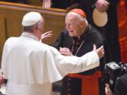 FILE - In this Sept. 23, 2015 file photo, Pope Francis reaches out to hug Cardinal Archbishop emeritus Theodore McCarrick after the Midday Prayer of the Divine with more than 300 U.S. bishops, at the Cathedral of St. Matthew the Apostle in Washington. On Tuesday, Nov. 10, 2020, the Vatican is taking the extraordinary step of publishing its two-year investigation into the disgraced ex-Cardinal McCarrick, who was defrocked in 2019 after the Vatican determined that years of rumors that he was a sexual predator were true.