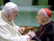 FILE - In this Feb. 23, 2001 file photo, U.S. Cardinal Theodore Edgar McCarrick, archbishop of Washington, D.C., shakes hands with Pope John Paul II during the General Audience with the newly appointed cardinals in the Paul VI hall at the Vatican. McCarrick was one of the three Americans on a record list of 44 new cardinals who were elevated in a ceremony at the Vatican on Feb. 21, 2001.