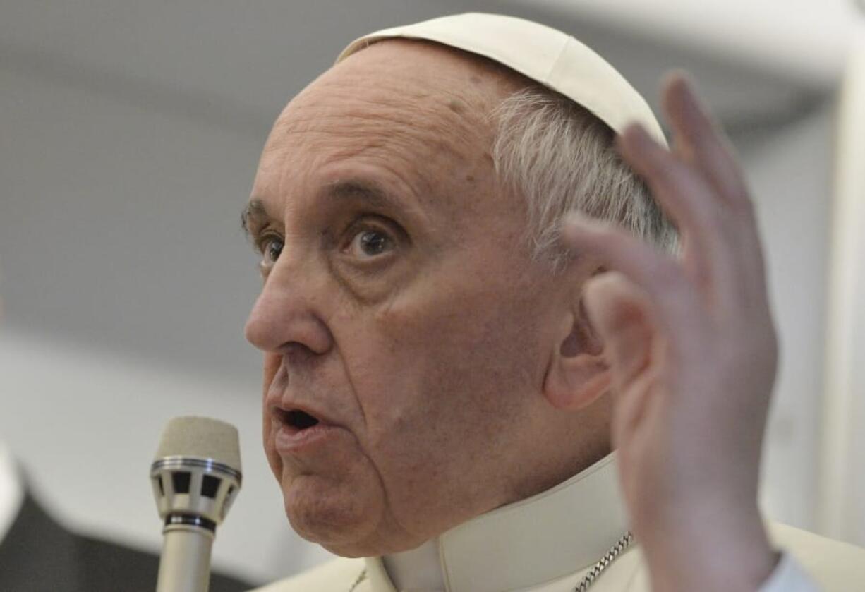 FILE - In this July 29, 2013 file photo, Pope Francis answers reporters questions during a news conference aboard the papal flight on the journey back from Brazil. Pope Francis&#039; famous quip &quot;Who am I to judge?&quot; ,  en route home from his first papal trip, could go a long way toward explaining his initial attitude toward Theodore McCarrick, the defrocked and disgraced American cardinal who was the subject of a two-year Vatican investigation that was released last week on Nov.