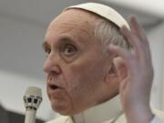 FILE - In this July 29, 2013 file photo, Pope Francis answers reporters questions during a news conference aboard the papal flight on the journey back from Brazil. Pope Francis&#039; famous quip &quot;Who am I to judge?&quot; ,  en route home from his first papal trip, could go a long way toward explaining his initial attitude toward Theodore McCarrick, the defrocked and disgraced American cardinal who was the subject of a two-year Vatican investigation that was released last week on Nov.