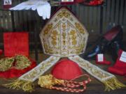 Cardinal clothing accessories are seen on display in the window of the Gammarelli clerical clothing shop, in Rome, Thursday, Nov. 26, 2020. The consistory to elevate new cardinals scheduled for Saturday, Nov. 28, in the time of coronavirus is like nothing the Holy See has ever seen. A handful of soon-to-be cardinals are in protective coronavirus quarantine, including African-American, Cardinal-designate Wilton Gregory, archbishop of Washington who explained that a U.S.-based ecclesiastical tailor took his measurements while he was still in Washington and sent them to Gammarelli, which then made them to order and sent them to Santa Marta hotel where he is undergoing the quarantine.