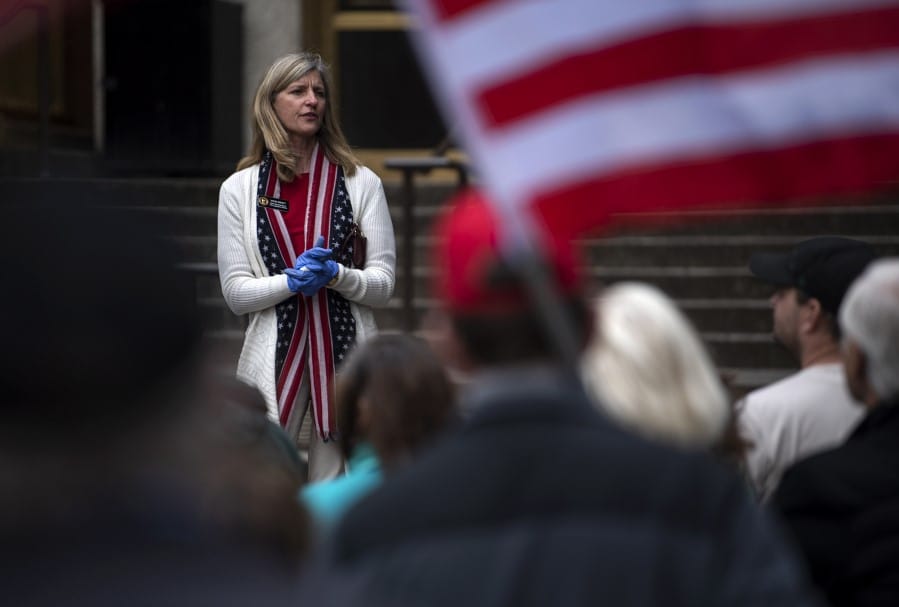 State Rep. Vicki Kraft, R-Vancouver, speaks to a crowd gathered in front of the Clark County Courthouse to protest Washington Gov. Jay Inslee's extension of coronavirus stay-at-home order in Vancouver in May 2020.