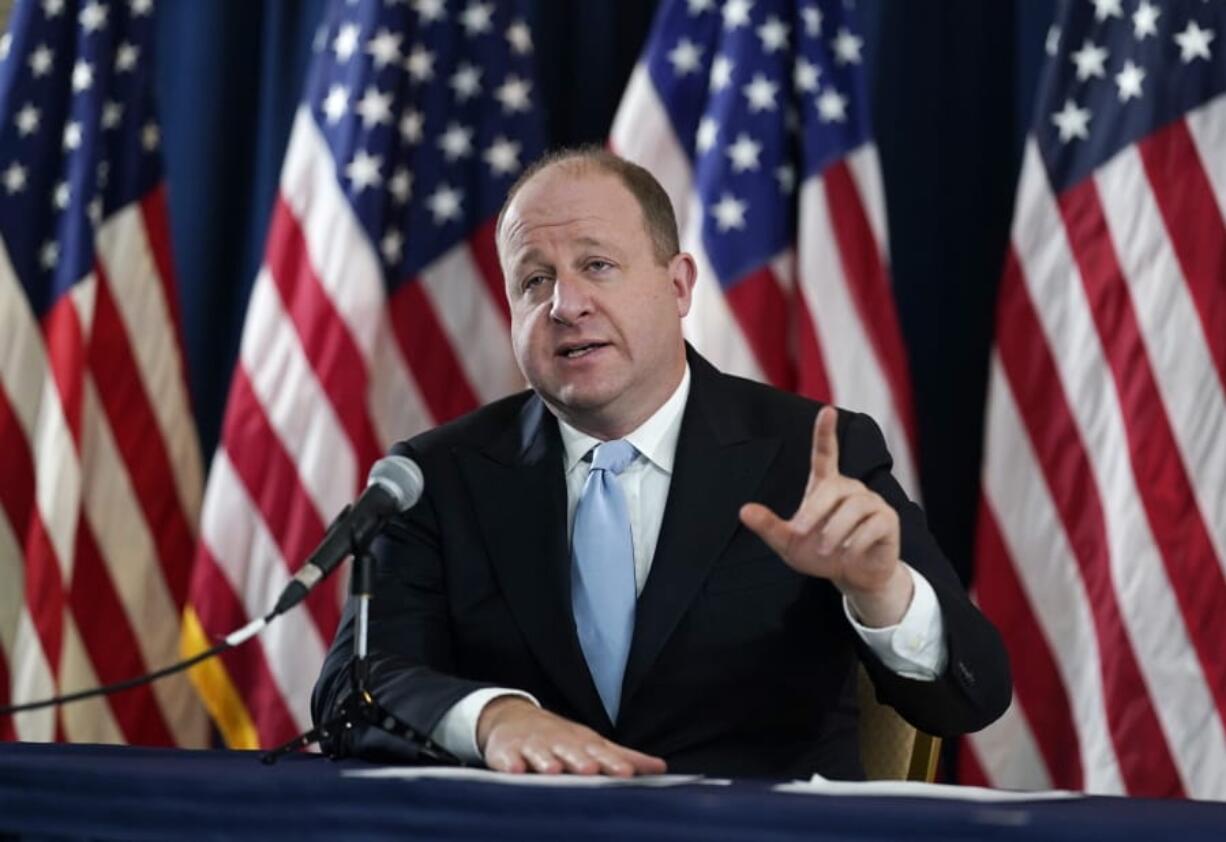 FILE - Colorado Gov. Jared Polis speaks during a news conference about the state&#039;s response to the rapid increase in COVID-19 cases, Tuesday, Nov. 24, 2020, in Denver.  Faulting inaction in Washington, governors and state lawmakers are racing to get needed pandemic relief to small businesses, the unemployed, renters and others affected by the widening coronavirus outbreak.