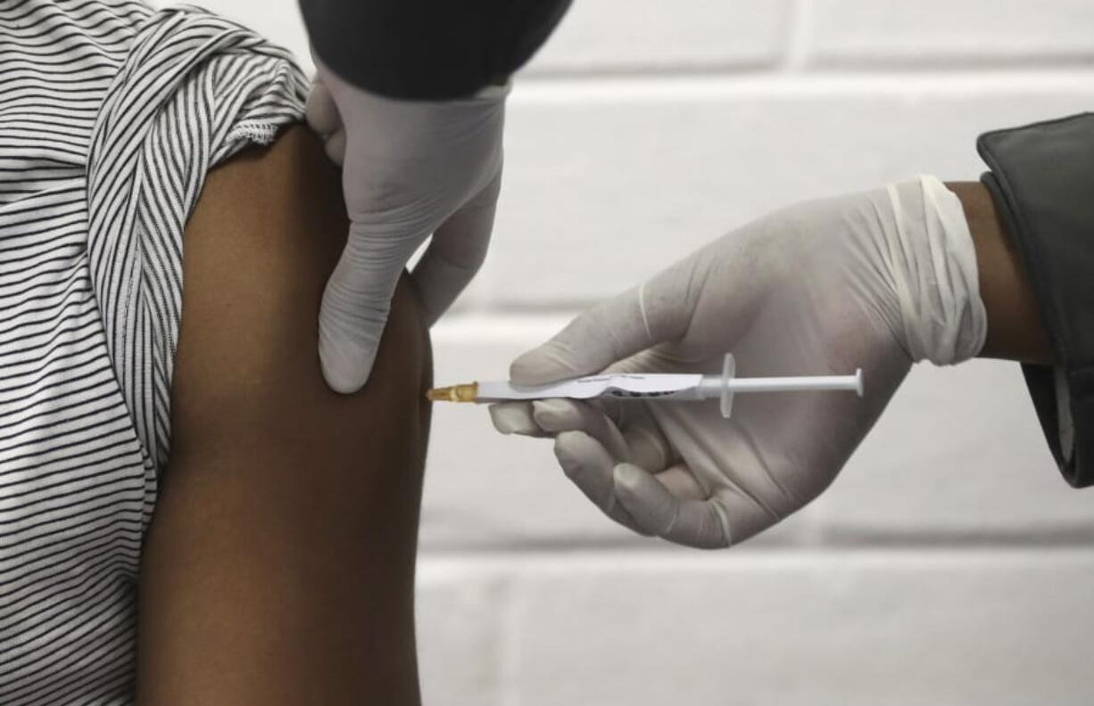 FILE - In this Wednesday, June 24, 2020 file photo, a volunteer receives an injection at the Chris Hani Baragwanath hospital in Soweto, Johannesburg, as part of Africa&#039;s first participation in a COVID-19 vaccine trial developed at the University of Oxford in Britain in conjunction with the pharmaceutical company AstraZeneca. AstraZeneca says late-stage trials of its COVID-19 vaccine were &quot;highly effective&#039;&#039; in preventing disease. A vaccine developed by AstraZeneca and the University of Oxford prevented 70% of people from developing the coronavirus in late-stage trials, the team reported Monday Nov. 23, 2020.