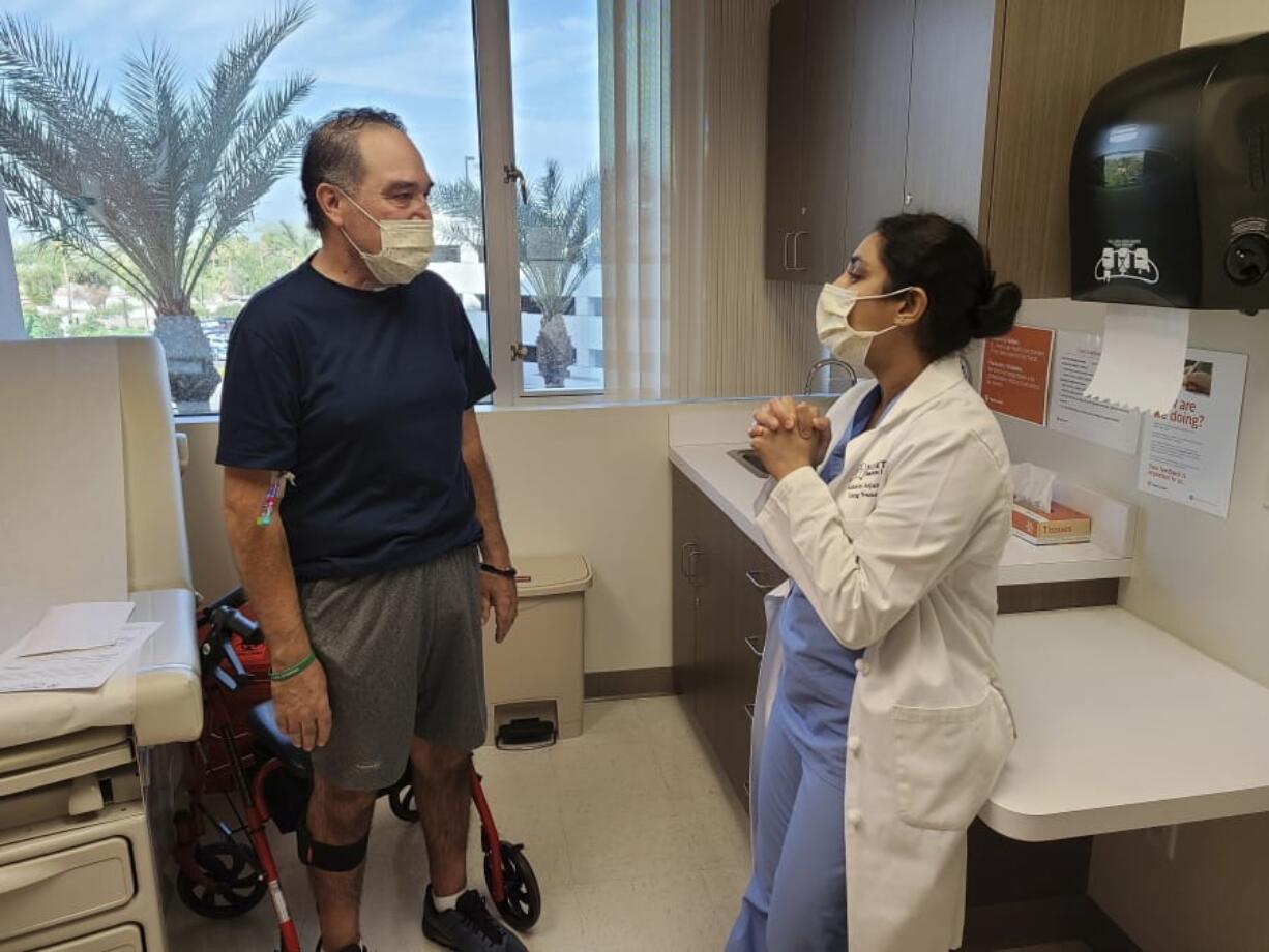 Arthur Sanchez, left, speaks with Dr. Ashwini Arjuna during a follow-up appointment, post-transplant, at St. Joseph&#039;s Hospital in Phoenix on Oct. 21. (Courtesy of Dignity Health St.