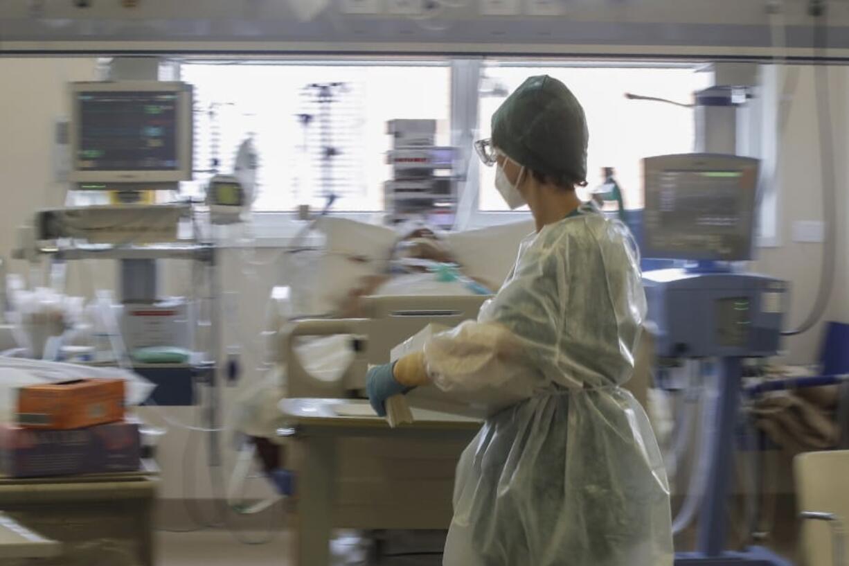 FILE - In this Friday, Nov. 6, 2020 filer, paramedic Alessandra works at the Intensive Care Unit of the &#039;Ospedale di Circolo&#039; hospital, in Varese, Italy.  Intensive care space is dwindling across Europe as beds fill again with coronavirus patients, this time in places that had been spared the virus peak from last spring.