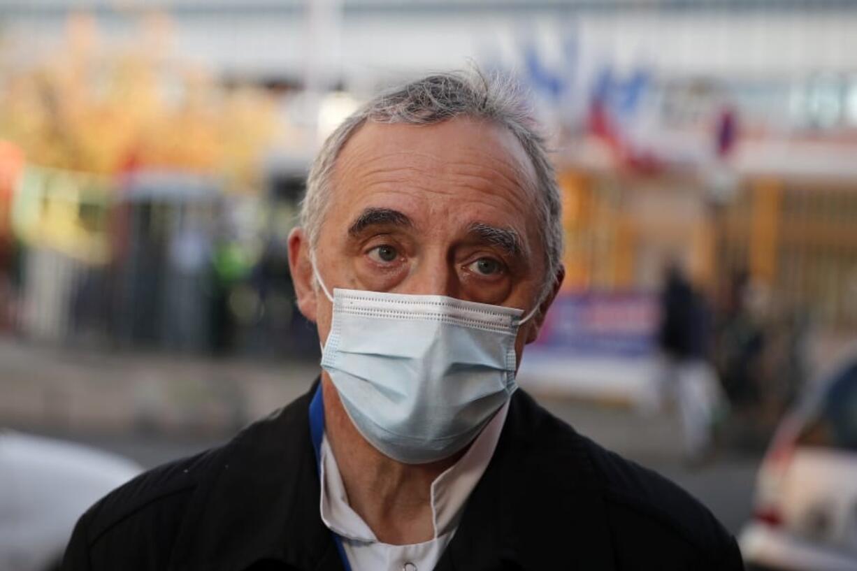 Dr. Philippe Montravers speaks with The Associated Press at the main entrance of the Bichat Hospital, in Paris on Tuesday, Nov. 10, 2020. Montravers and the 150 doctors and nurses he leads have become experts about how to treat COVID-19. That knowledge is proving invaluable against a second deadly surge of the virus is again threatening to overwhelm European health systems.