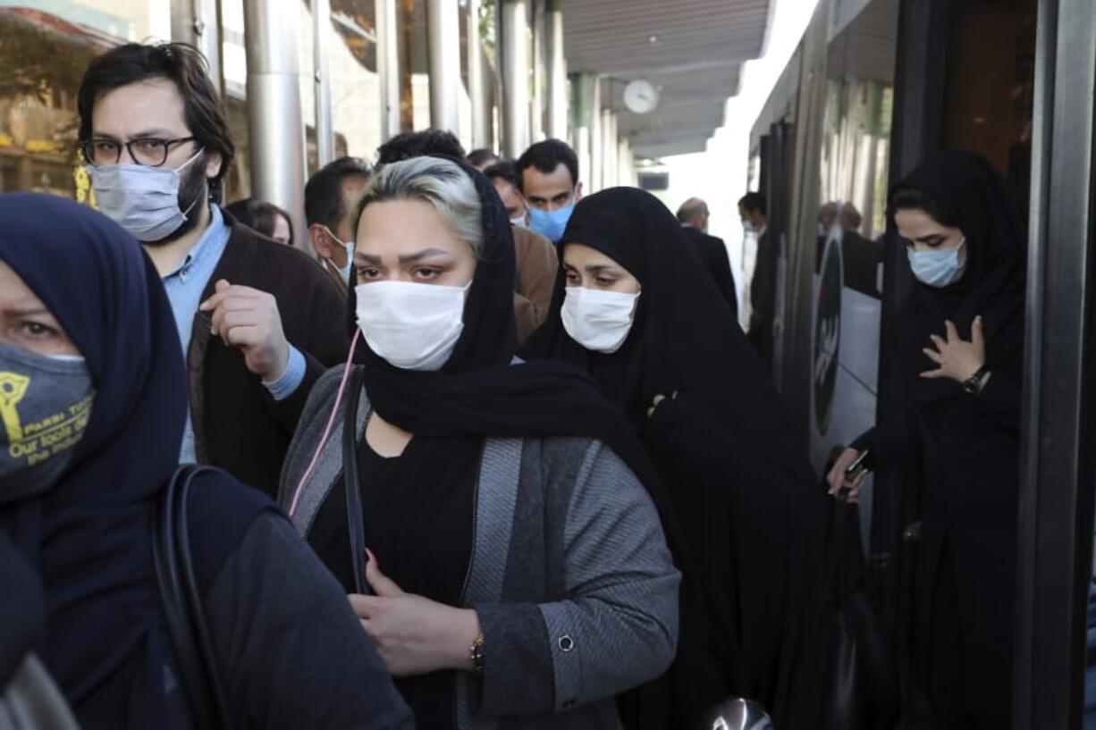 FILE - In this Sunday, Oct. 11, 2020 file photo, people wear protective face masks to help prevent the spread of the coronavirus in downtown Tehran, Iran. For the third time in a week, Iran on Wednesday marked its highest single-day record for new deaths and infections from the coronavirus, with 279 people killed and 4,830 new patients.