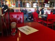 A Red Robin restaurant in Tigard, Ore., has closed some tables in order to maintain social distancing between diners per CDC guidelines in March. Much of Oregon is under a new round of restrictions.