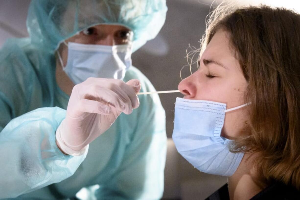 A health worker collects a nose swab sample for a polymerase chain reaction (PCR) test at the Mycorama coronavirus testing facility during the coronavirus disease (COVID-19) outbreak, in Cernier, Switzerland, Tuesday, Nov. 3, 2020.