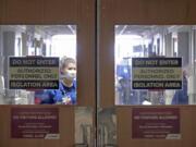 FILE - In this Nov. 5, 2020, file photo, doors to a COVID-19 treatment unit at UW Health in Madison, Wis., caution hospital personnel and visitors. Conditions inside the nation&#039;s hospitals are deteriorating by the day as the coronavirus rages through the country at an unrelenting pace.