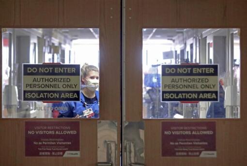 FILE - In this Nov. 5, 2020, file photo, doors to a COVID-19 treatment unit at UW Health in Madison, Wis., caution hospital personnel and visitors. Conditions inside the nation&#039;s hospitals are deteriorating by the day as the coronavirus rages through the country at an unrelenting pace.