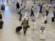 FILE - In this Nov. 12, 2020, file photo, travelers make their way through the Minneapolis-St. Paul International Airport during the coronavirus pandemic. With the coronavirus surging out of control, the nation&#039;s top public health agency advised Americans on Thursday, Nov.