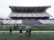 Washington players and coaches take part in NCAA college football practice, Friday, Oct. 16, 2020, at Husky Stadium in Seattle. (AP Photo/Ted S.