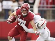 FILE - In this Nov. 16, 2019, file photo, Washington State running back Max Borghi, left, carries the ball during the first half of an NCAA college football game in Pullman, Wash. Borghi is likely to get more rushing attempts under the new Washington coach Nick Rolovich.