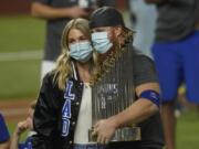 Los Angeles Dodgers third baseman Justin Turner celebrates with the trophy after defeating the Tampa Bay Rays 3-1 to win the baseball World Series in Game 6 Tuesday, Oct. 27, 2020, in Arlington, Texas.