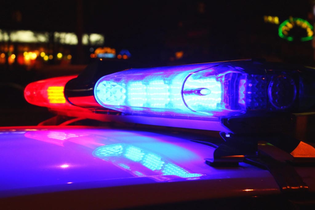 A close-up photo of police lights by night