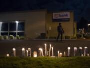 Candles in memory of Kevin Peterson Jr. are seen at the Hazel Dell branch of U.S. Bank on Oct. 30.