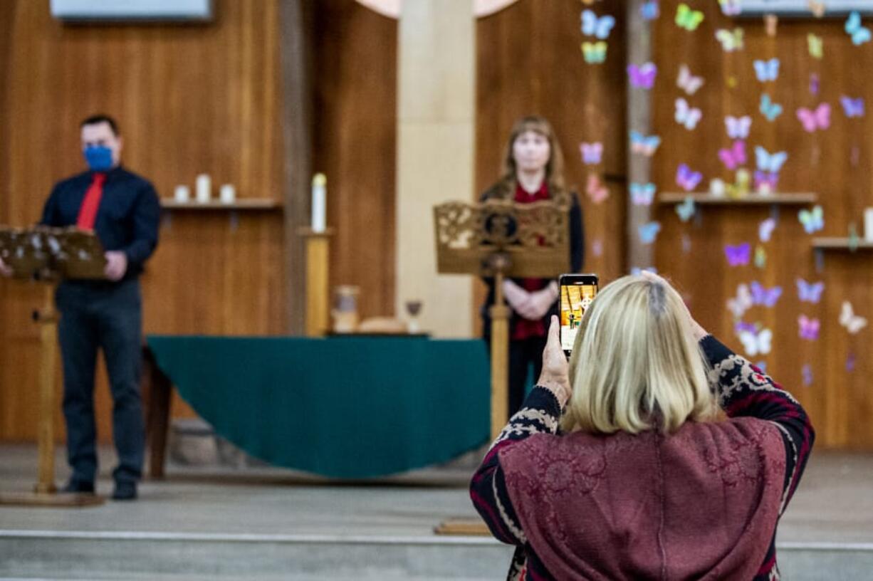 Joshua Hart/The Columbian 
 Vancouver Master Chorale soloists Ryan Allen, left, and Amy Christenson, center back, prepare to sing while  director Jana Hart positions her phone for recording on a recent Saturday morning at  First Presbyterian Church in Vancouver.