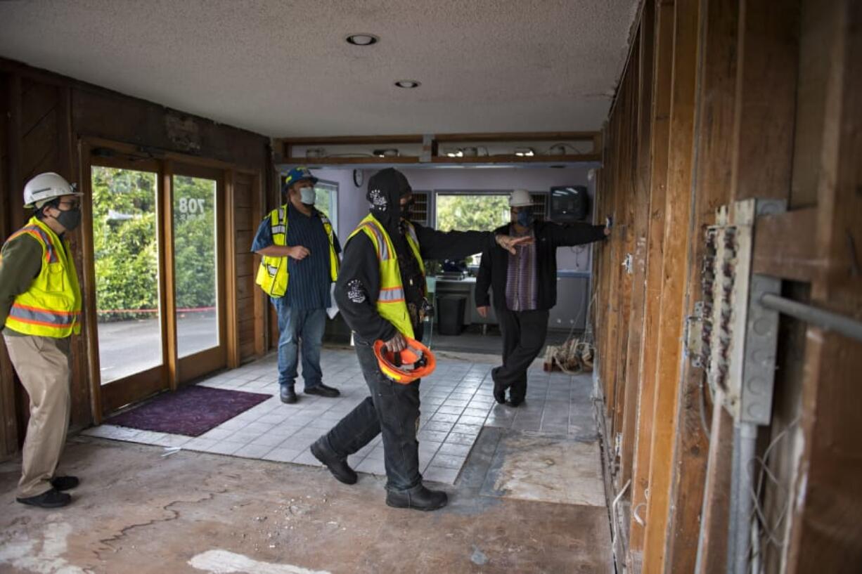 James Kasper, center, talks with advisers about his future vision for the Value Motel in Hazel Dell, which is being transformed into a recovery house.