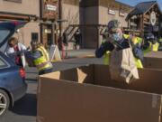 Volunteers collect donations during the Drive &amp; Drop food drive Dec. 4 at Chuck&#039;s Produce.