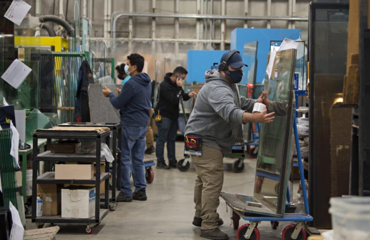 Oscar Paniagua of Peninsula Glass, right, helps prepare an order for a customer while working with colleagues. Peninsula Glass was named 2020 Small Business of the Year by the Greater Vancouver Chamber of Commerce.