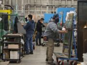 Oscar Paniagua of Peninsula Glass, right, helps prepare an order for a customer while working with colleagues. Peninsula Glass was named 2020 Small Business of the Year by the Greater Vancouver Chamber of Commerce.