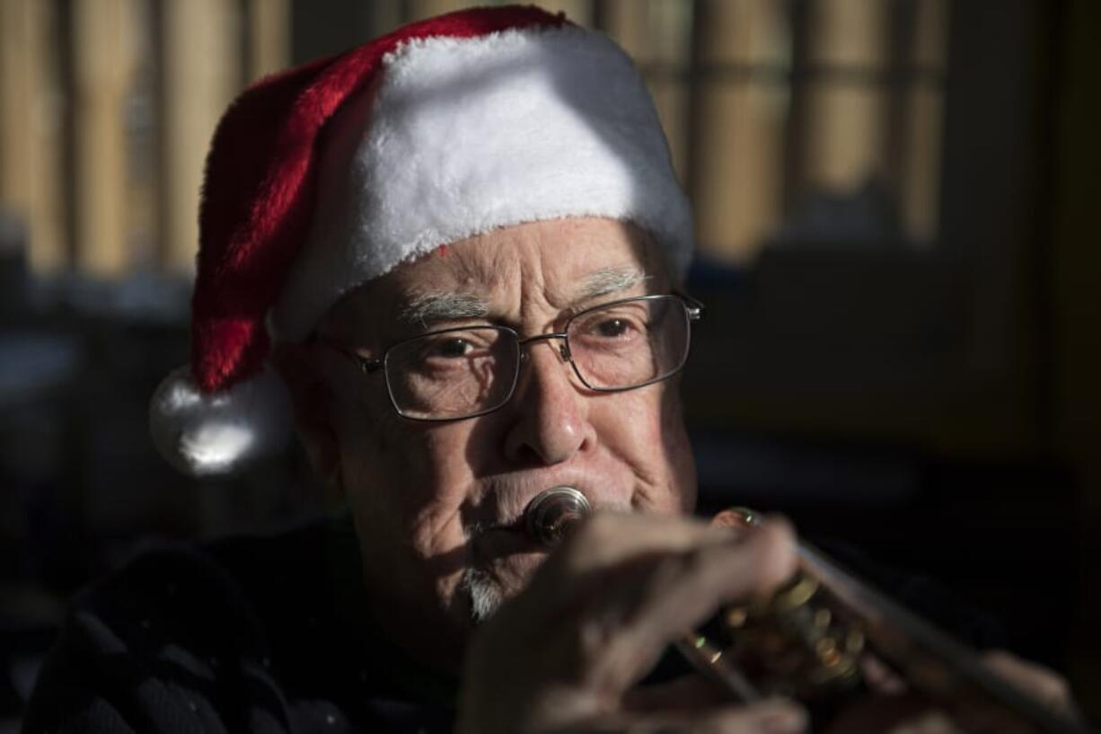 Former Fort Vancouver High School band director Ray B. Johnson plays a trumpet in his home music studio. Johnson is trying to find members of his 1977 stage band to share a CD made on their last day of class with all sorts of classic big band tunes.
