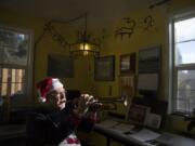 Former Fort Vancouver High School band director Ray B. Johnson plays a trumpet in his home music studio. Johnson is trying to find members of his 1977 stage band to share a CD made on their last day of class with all sorts of classic big band tunes.